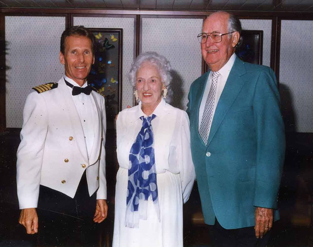 Don and G with the captain on one of the many cruises they enjoyed